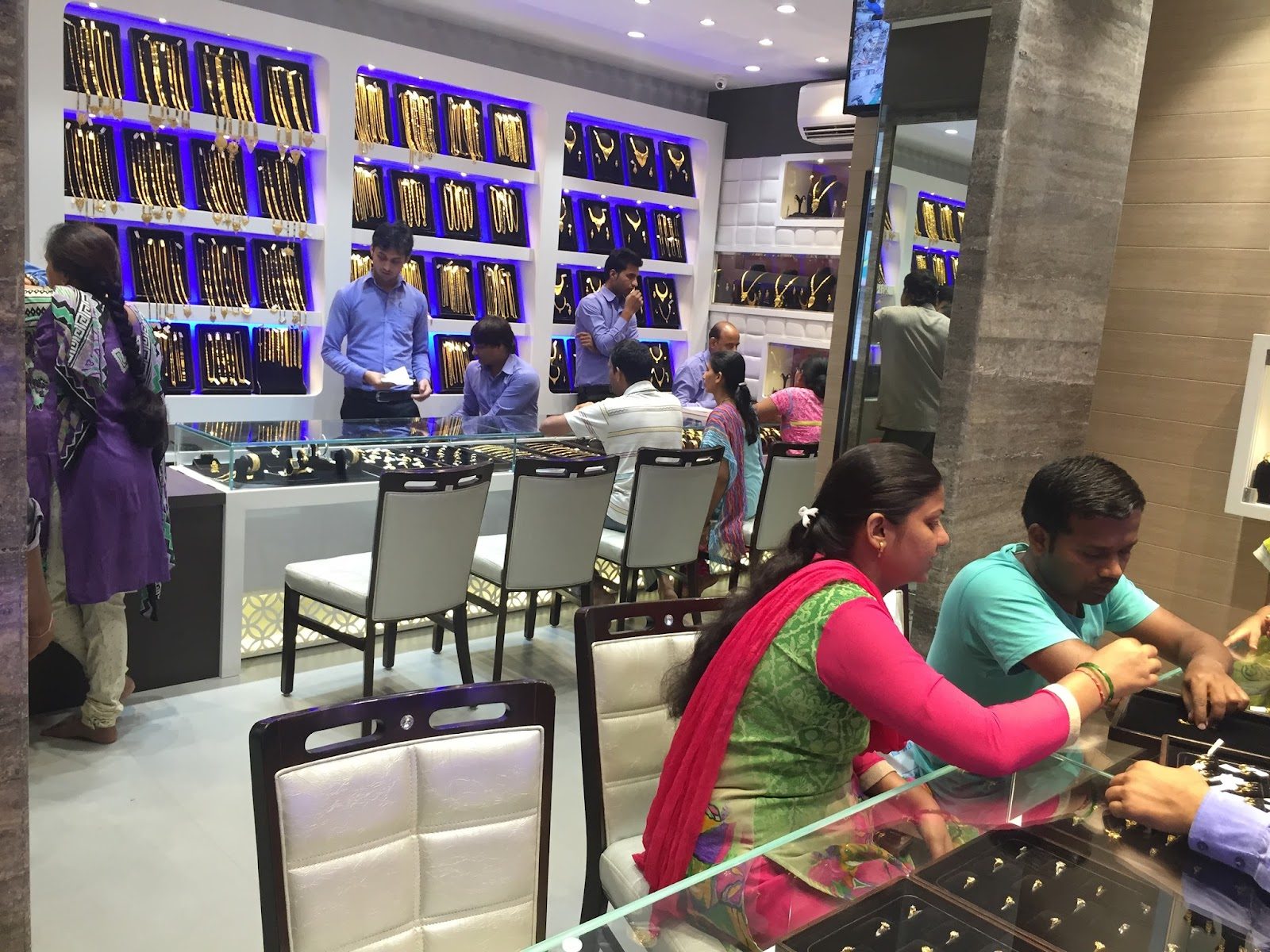 Bhayandar showroom floor, customers at the counters.